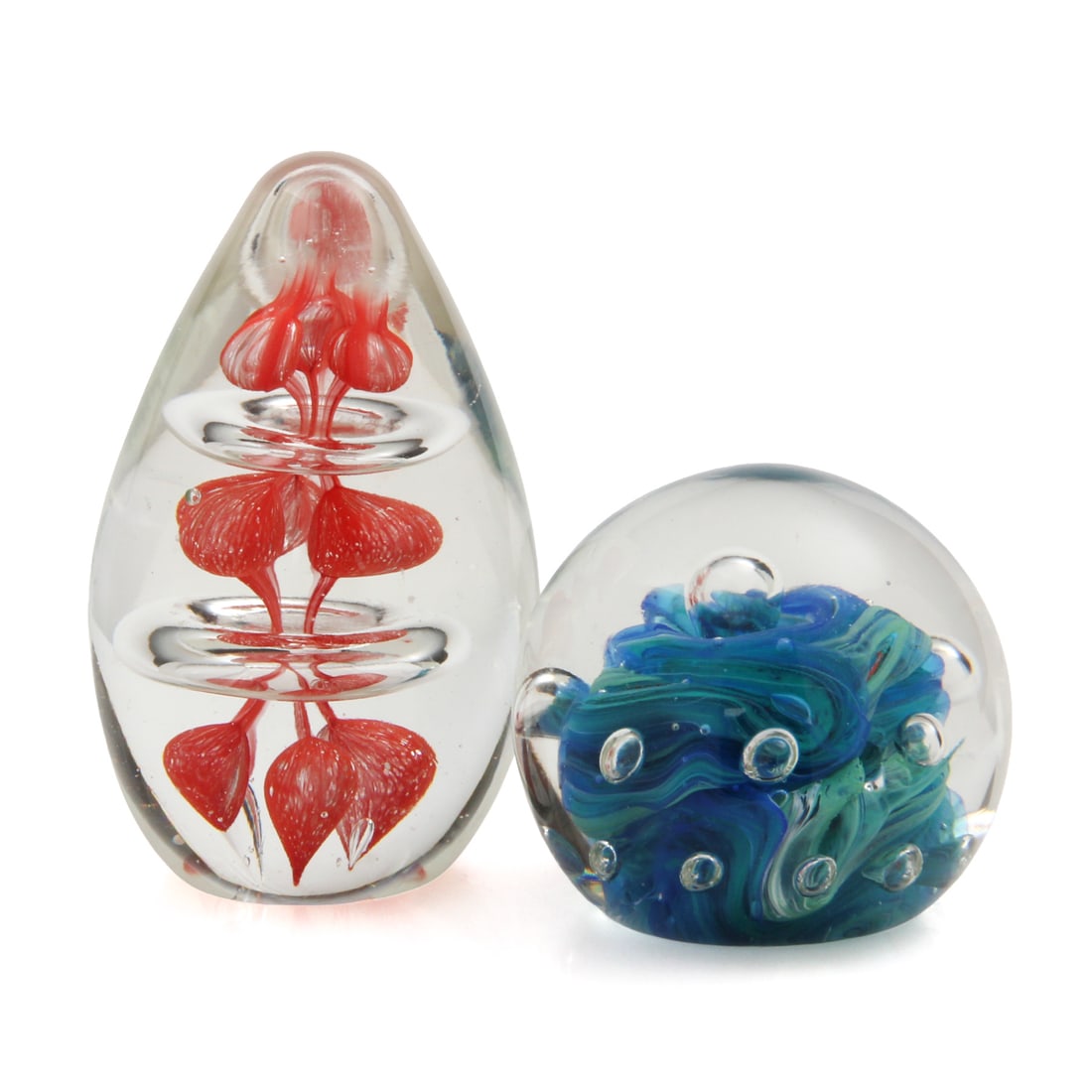 Hand Blown Art Glass Paperweights, Pair: A pair of hand blown art glass paperweights. one is egg shaped with a red and clear glass design, the other has a bubble design with swirling blue and green colors. 2.5w, 4.5h (of tallest piece).