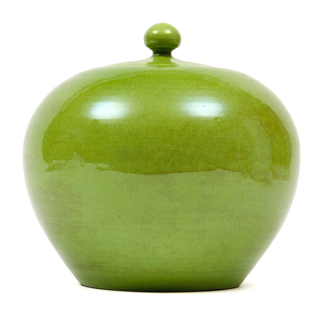 Green Crackle Glazed Chinese Lidded Jar: A lidded chinese jar with a bright green crackle glaze that carries notes of brown. Marked with chinese characters to bottom. 9w, 9h inches.