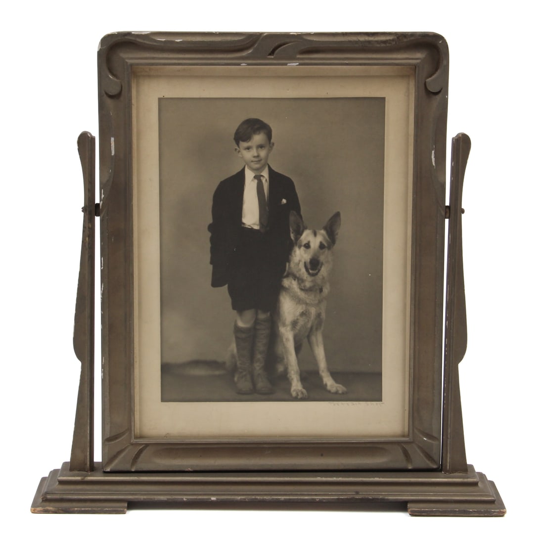 1930s Cheval Swivel Wood Frame: An antique swivel cheval wood carved mirror. Piece retains its original label from the S. Spencer Moore Company Store. Frame houses an original portrait of a boy with a german shephard dog. 14.25w,