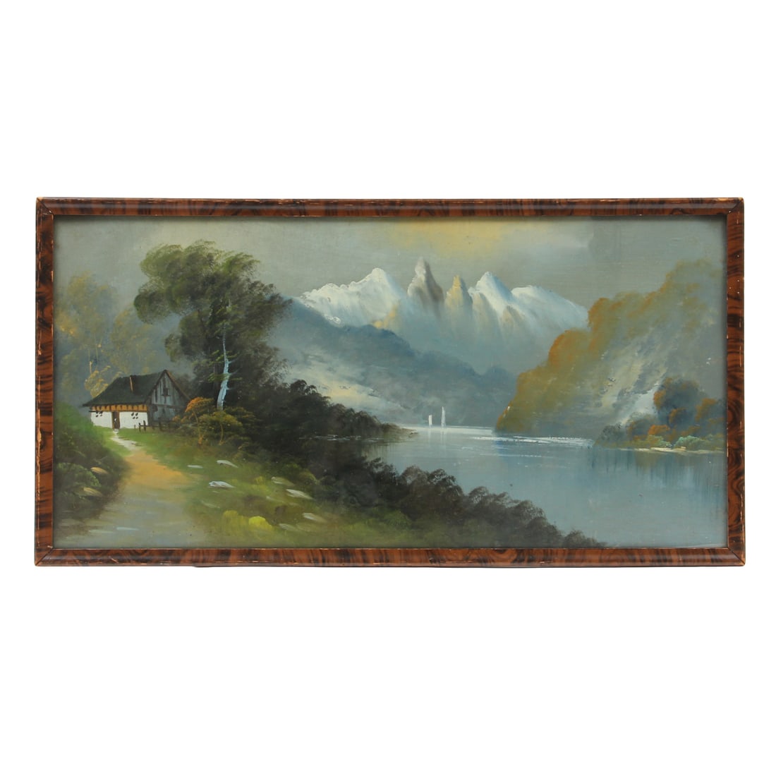 Vintage Cabin by The Lake Painting: A vintage oil painting depicitign a cabin by a lake with mountains in the distance, housed in a wood frame under glass. 29w, 15h inches.