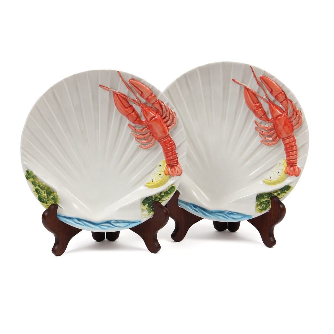 Italian Porcelain Lobster/Shell Plates, Pair: A pair of Italian porcelain plates with a shell and lobster design. These plates have a three dimnesional design depicting a shell, lobster, lemon, water and vegetation. Pieces are marked "MADE IN ITA