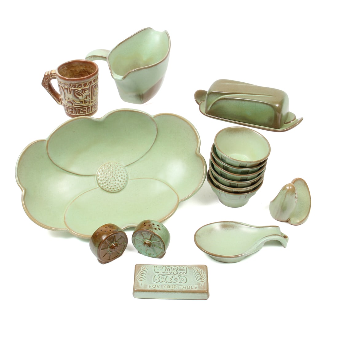 Frankoma Pottery Serving Pieces: A collection of vintage green and brown glazed pottery by Frankoma. This lot includes A pair of salt and pepper shakers, one floral serving bowl, a Warm Bread plaque, lidded butter dish, 6 small bowls