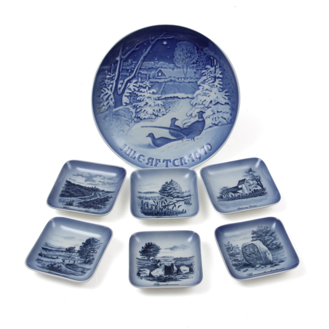 Royal Copenhagen Porcelain: A collection of Copenhagen porcelain plates including one 7.25" Bing & Grondhl christmas plate, and 6 Royal Copenhagen 3.25" scenic dishes.