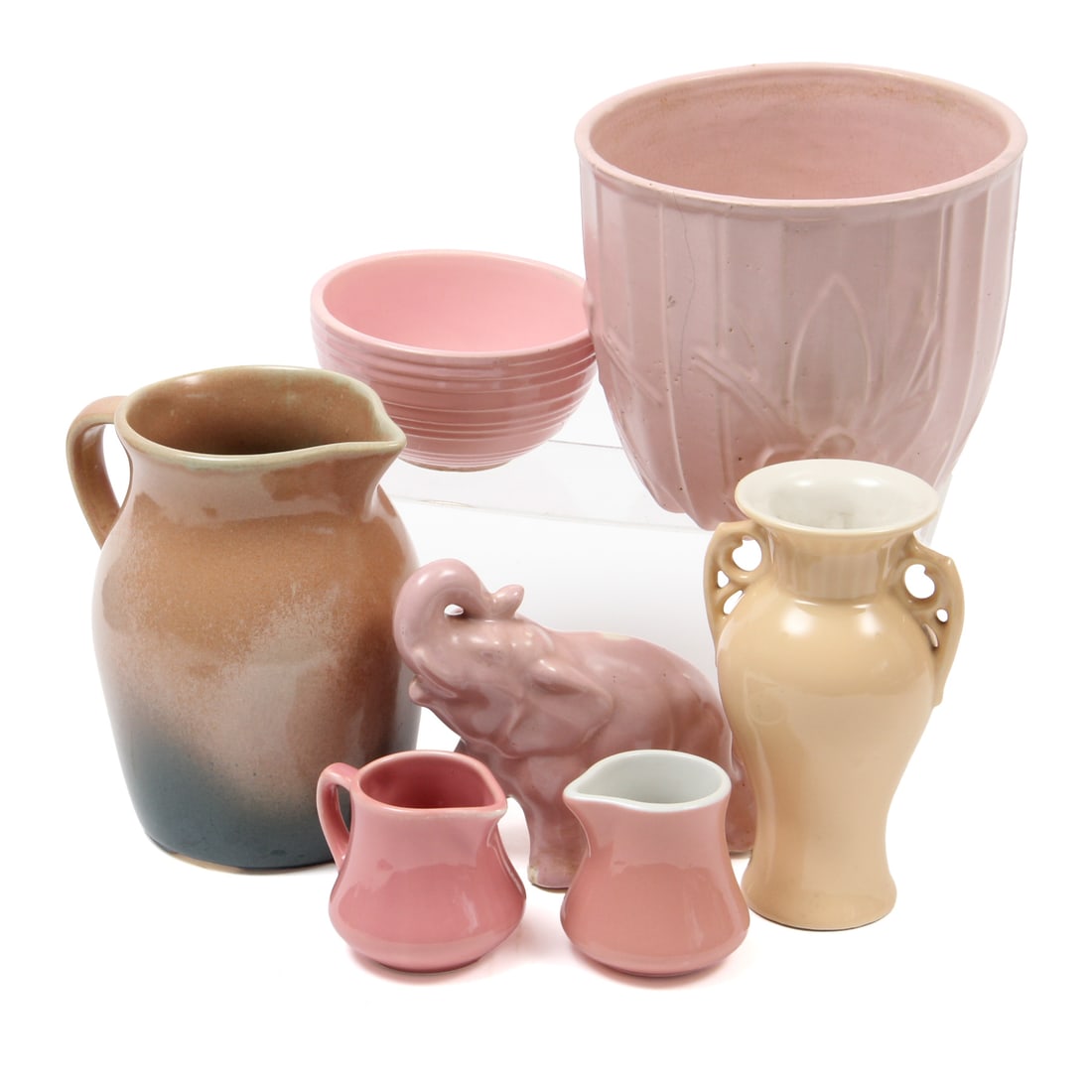 Collection of Pink Mid Century Pottery Pieces: A collection of pink colored mid century modern pieces by a variety of makers including Mccoy, Abingdon, Owl Creek and more.
