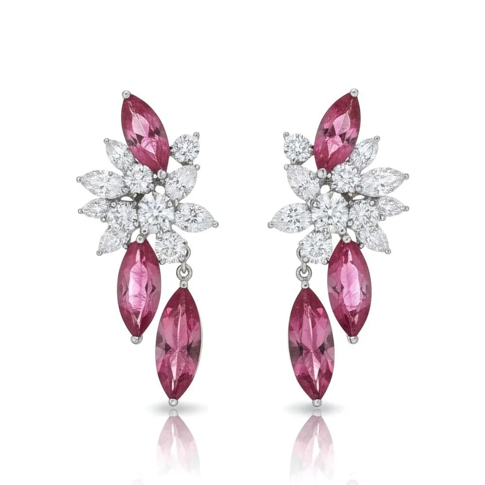 Marquise Ruby 18K White Gold Diamond Floral Drop Earrings: Radiant and refined, these earrings are masterfully crafted in 18K white gold, showcasing the fiery elegance of marquise-cut rubies and the brilliance of round and marquise-cut diamonds. Each earring 