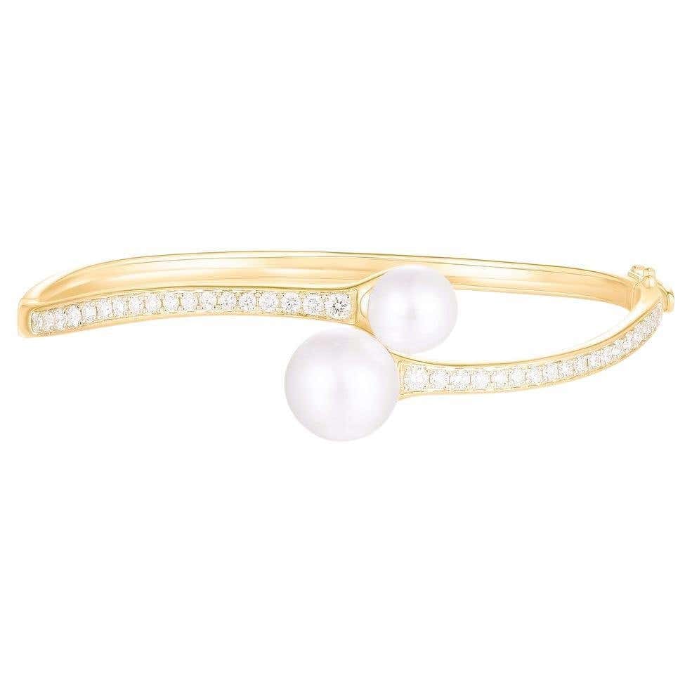 Double Pearl Diamond 14K (or 18K upon request) Yellow Gold Open Bangle Bracelet: Timeless elegance meets modern sophistication in this Double Pearl and Diamond Open Bangle Bracelet, beautifully crafted in 14K Yellow Gold (available in 18K upon request). Two luminous white pearls r