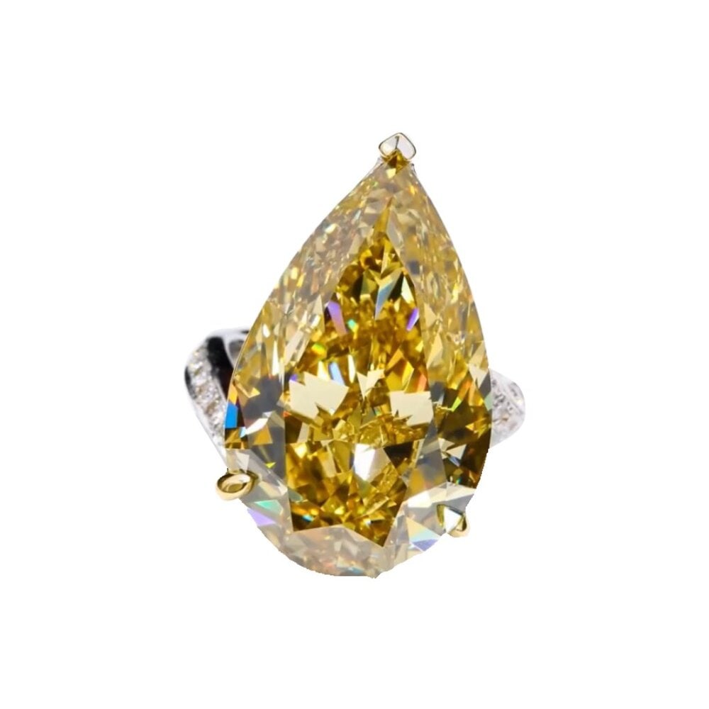 Yellow Diamond Pear Statement Ring 18K in Yellow Gold: Make a luminous entrance with this Yellow Diamond Pear Statement Ring crafted in rich 18K yellow gold. The elegant pear-shaped yellow diamond sits center stage, catching and reflecting light with ever