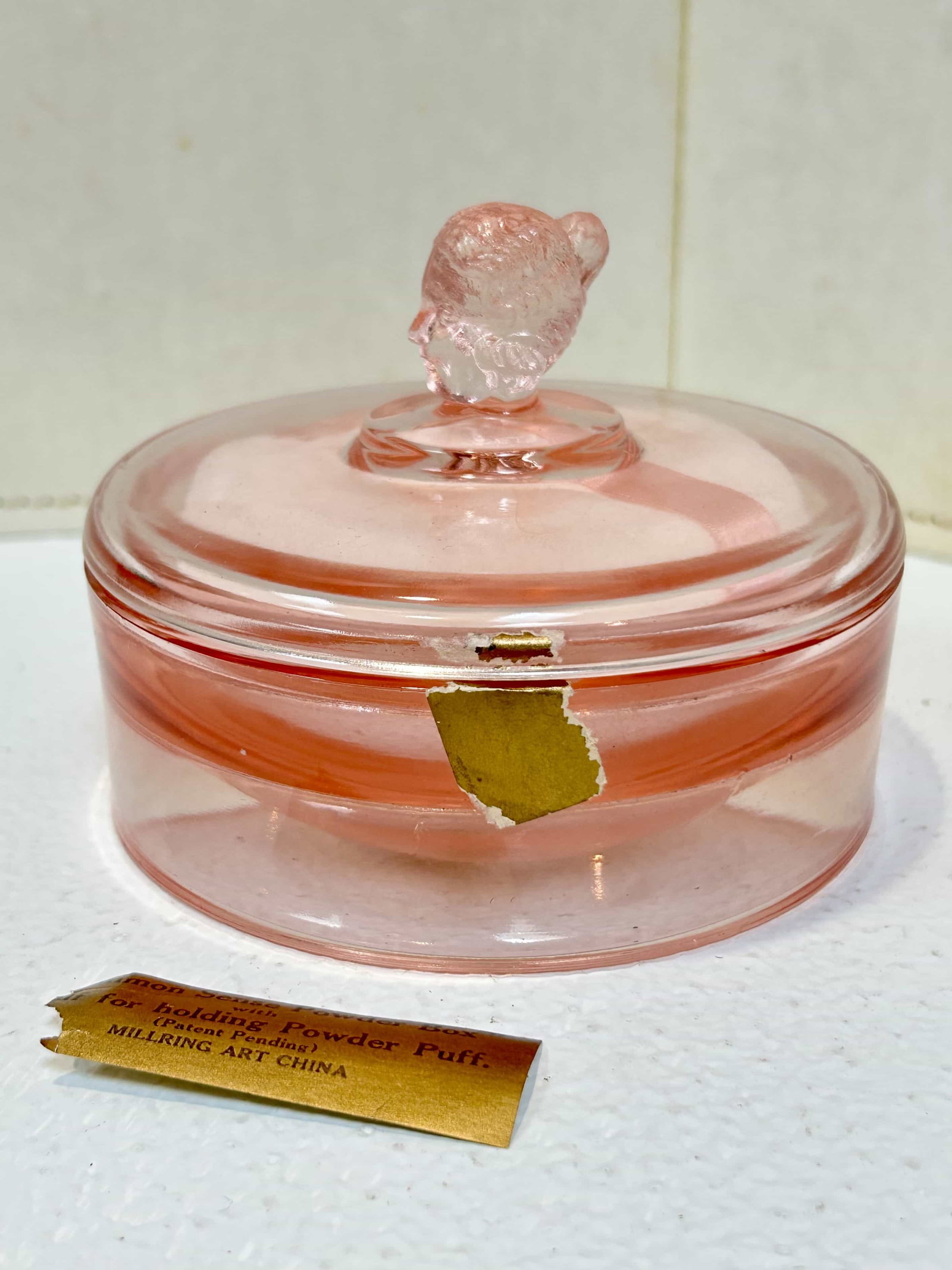 McKee Pink Glass Annabella Vanity Powder Jar: Scarce pink Annabella vanity powder jar made by McKee Glass Co. Measures 4.75" diameter. Condition is good with no visible chips or cracks. Has original powder puff, and retains some of the original l