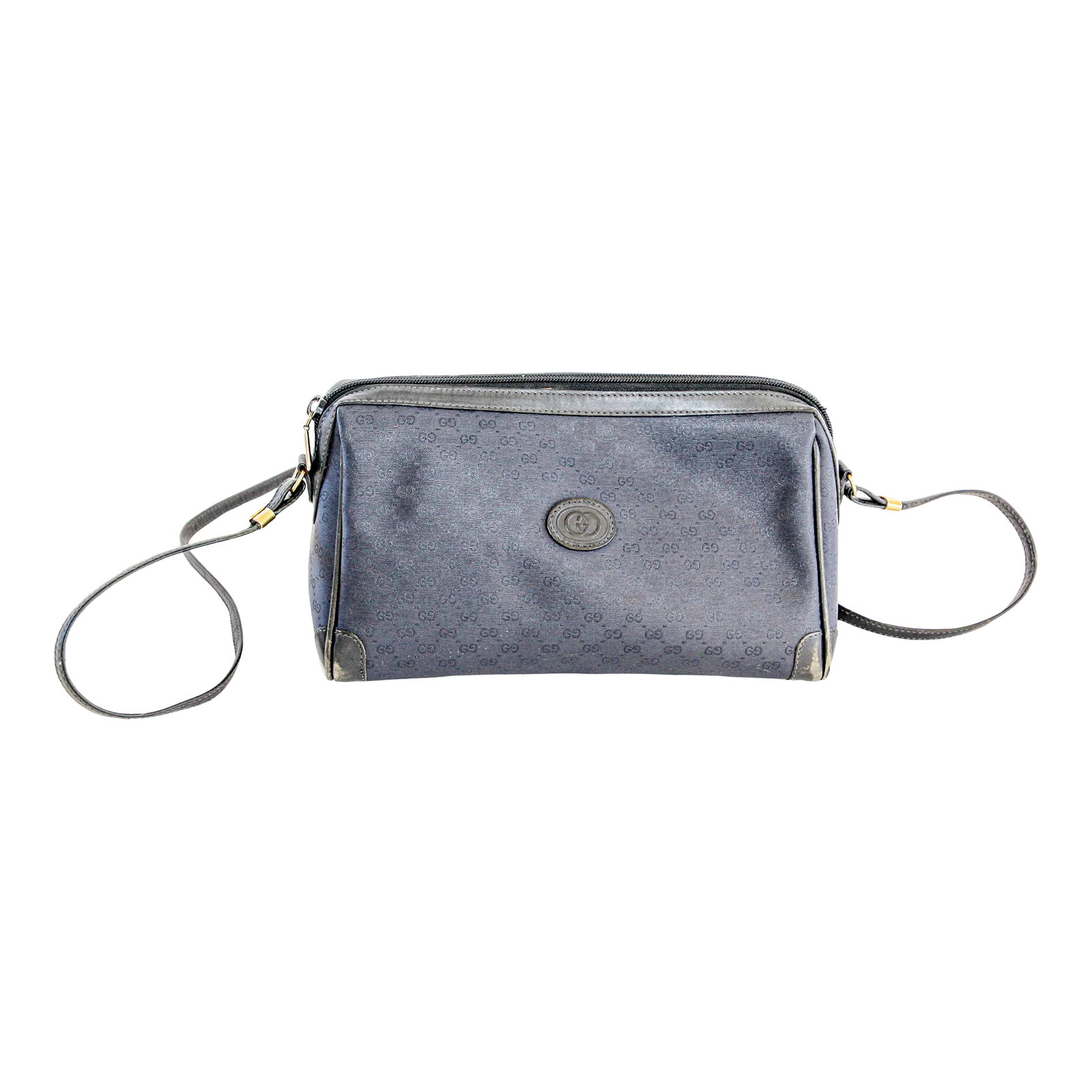 GUCCI Monogram Navy Handbag: A rare vintage navy leather GUCCI monogram handbag. The older Gucci pieces are highly sought after and increasingly hard to find. Navy blue coated canvas bag with allover tonal monogram logo print GG