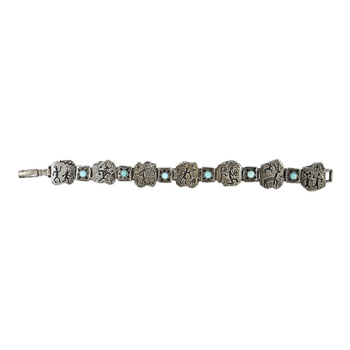 Late 20th Century Sterling Silver and Turquoise Link Bracelet: Late 20th century sterling silver and turquoise link bracelet. Marked sterling and with makers mark for Shube's Manufacturing Inc. Albuquerque. Each link is a cast rock art style figure with each