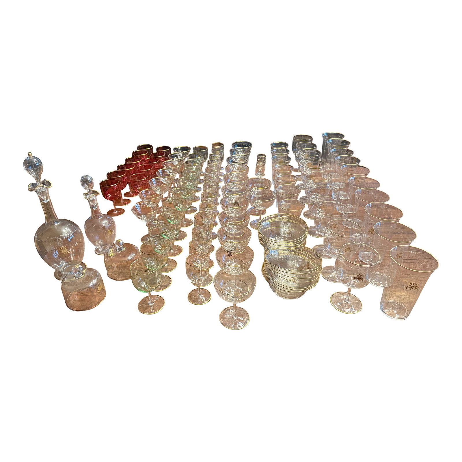 101 Pc, Belle Époque Gilt-Monogrammed Crystal Service, in the Manner of Baccarat: A lavish turn-of-the-century crystal service of exceptional quality, hand-blown and wheel-engraved with a continuous beaded festoon border and finished with fire-gilded rims, stoppers, and bases. Each
