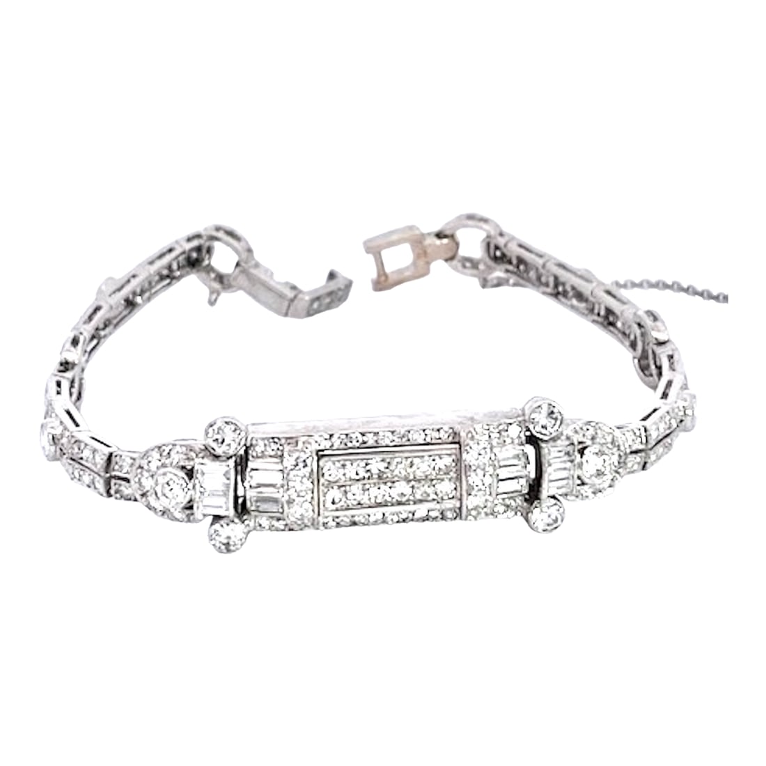1930s Art Deco Diamond Platinum Bracelet: This stunning platinum bracelet exemplifies Art Deco elegance, featuring an elaborate centerpiece adorned with a mix of round brilliant and baguette-cut diamonds set in a geometric, architectural