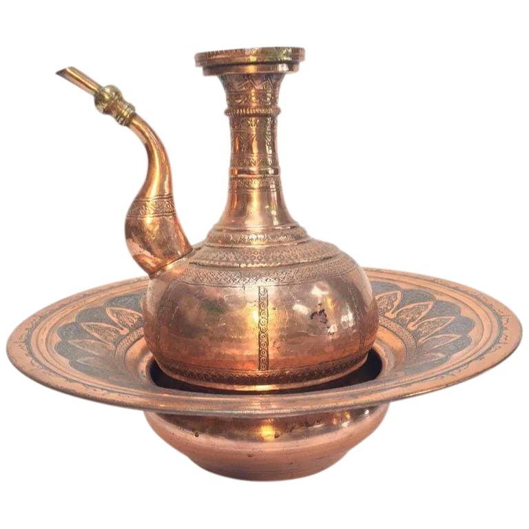 Antique Middle Eastern Islamic Turkish Ewer and Copper Basin: Handcrafted antique 19th century copper Middle Eastern ewer with basin. The ewer with a rounded body, on short splayed foot, engraved with geometric designs with slightly waisted neck, slender