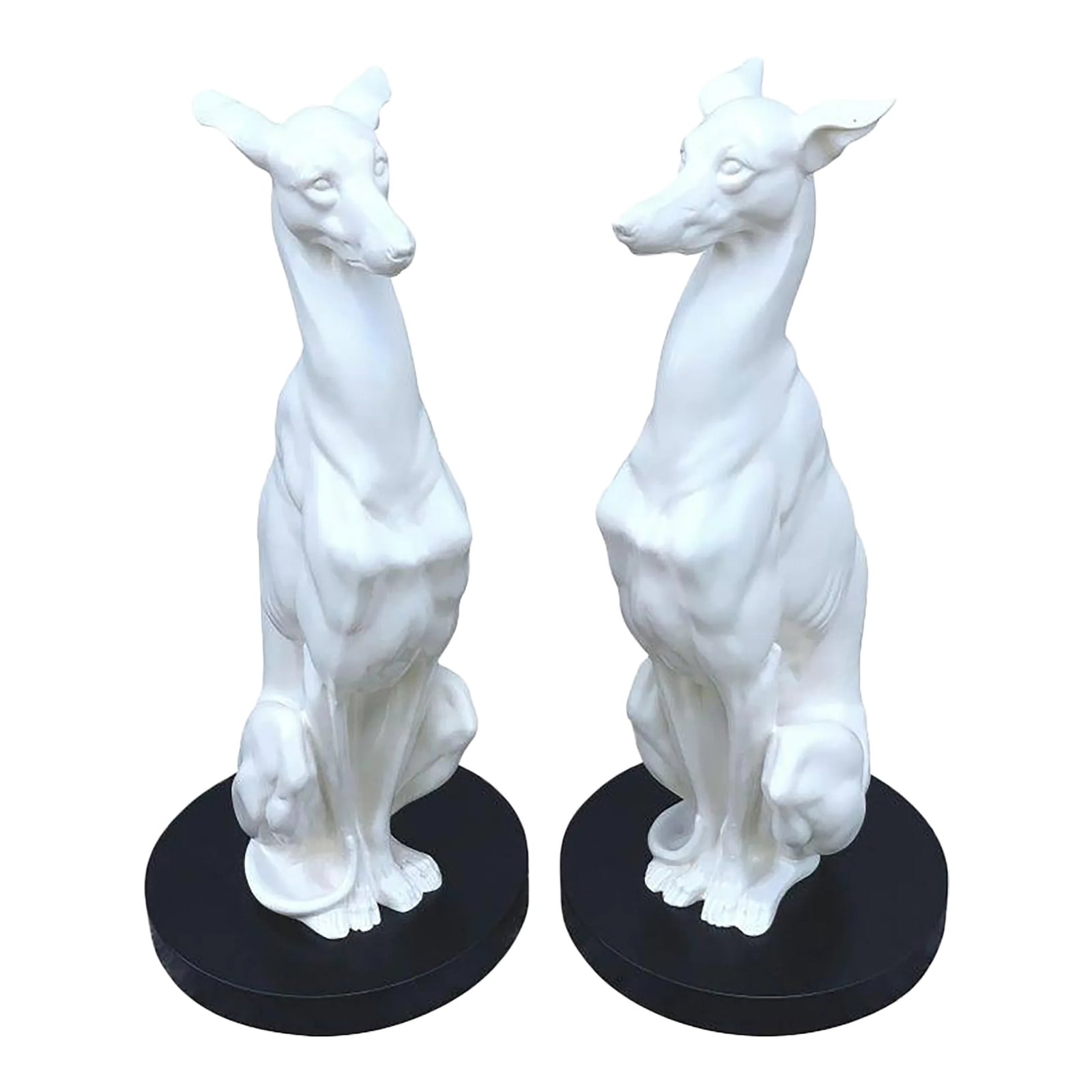 Mid 20th Century Hollywood Regency Black and White Whippets - a Pair: Pair of Hollywood Regency black and white whippets, each one life size, of seated form, realistically modeled, raised on a 14" circular wood base. The figure alone measures 30 inches high. Condition: