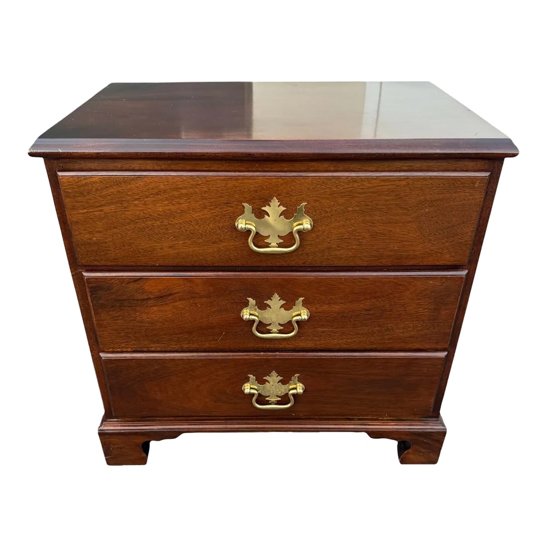 Late 20th Century Queen Anne Three Drawer Chest: Quick Hits: - Late 20th century Queen Anne three-drawer chest - Rich mahogany finish with classic Queen Anne styling - Elegant brass hardware with leaf motifs - Perfect for bedrooms, living rooms, or