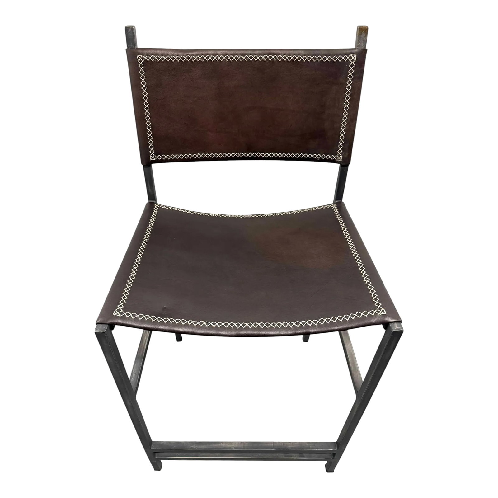 Sol & Luna Brown Leather and Iron Counter Stool: Quick Hits: - Sol & Luna Brown Leather and Iron Counter Stool - Sleek brown leather seat with iron frame for a modern, industrial vibe - Stitched detailing adds character and craftsmanship - Perfect