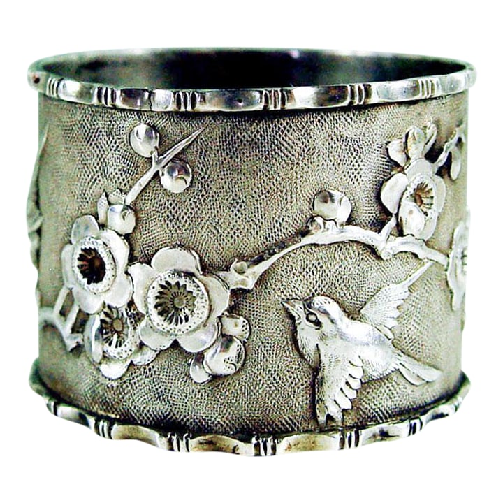 Aesthetic Movement Sterling Silver Birds Cherry Blossoms Chinese Export Napkin Ring: A single antique Aesthetic Movement Chinese export sterling silver napkin rings circa 1900. With repousse cherry blossoms and birds, oval medallion with "P" engraved monogram. Stamp mark inside.