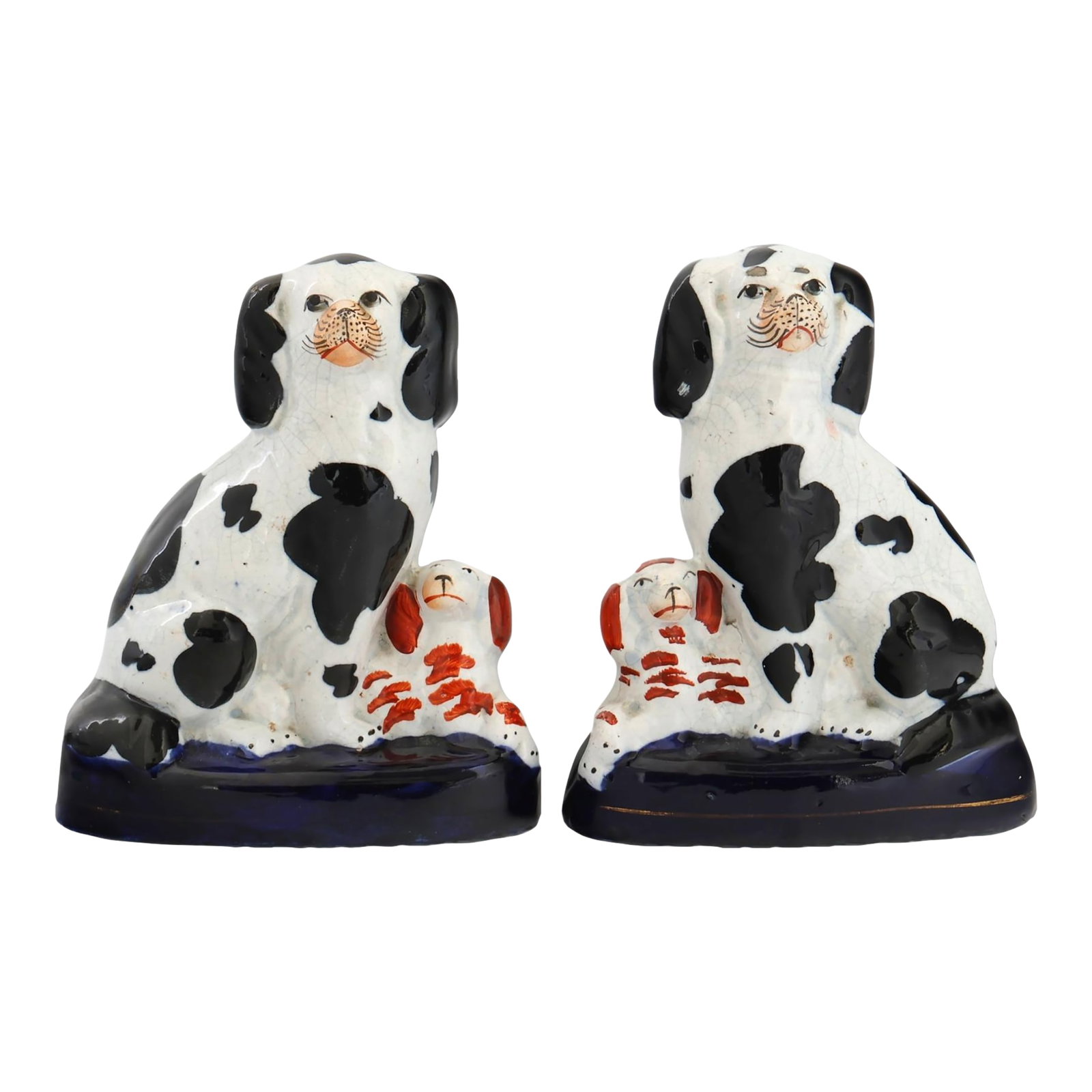 19th Century Staffordshire King Charles Dogs W/Pups: Late 19th century pair of English Staffordshire dogs with pups, featuring classic hand-painted decoration and traditional seated form. The expressive modeling and glossy glaze reflect the charm and