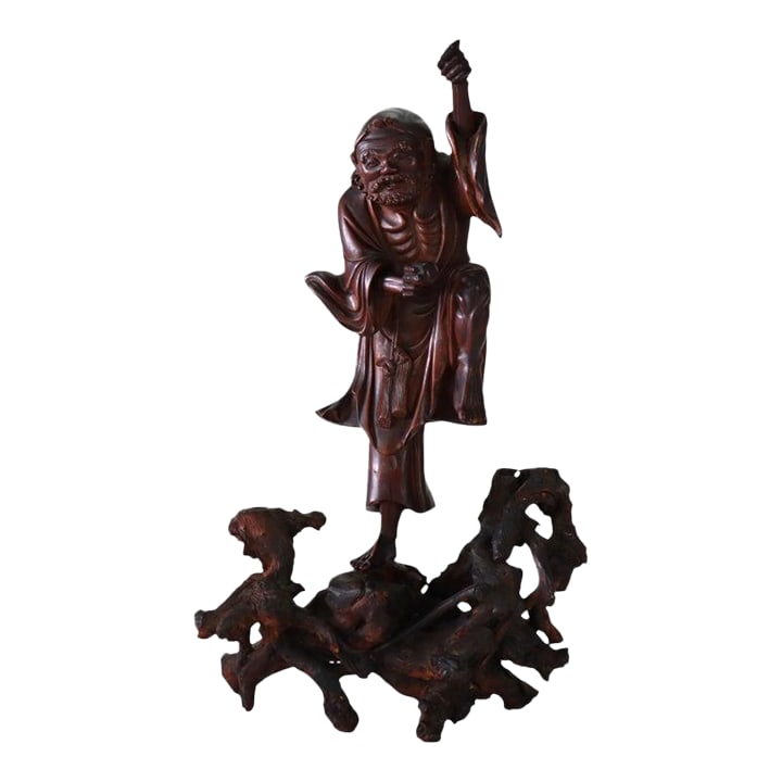 Chinese Carved Wood Folklore Figure With Wood Base 19thC - Set of 2: A 19th Century Chinese carved wood folklore figure, presented on a natural root wood base. This finely rendered sculpture, originating from China, depicts a revered sage or immortal, standing in a