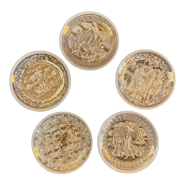 1960s Set of 5 Piero Fornasetti Mitologia Gilt Porcelain Plates, Italy: Set of 5, Italian, mid century, small plates or coasters by Piero Fornasetti, made exclusively for retailer Bonwitt Teller. The plates feature the "Mitologia" (Mythological) pattern, hand painted in