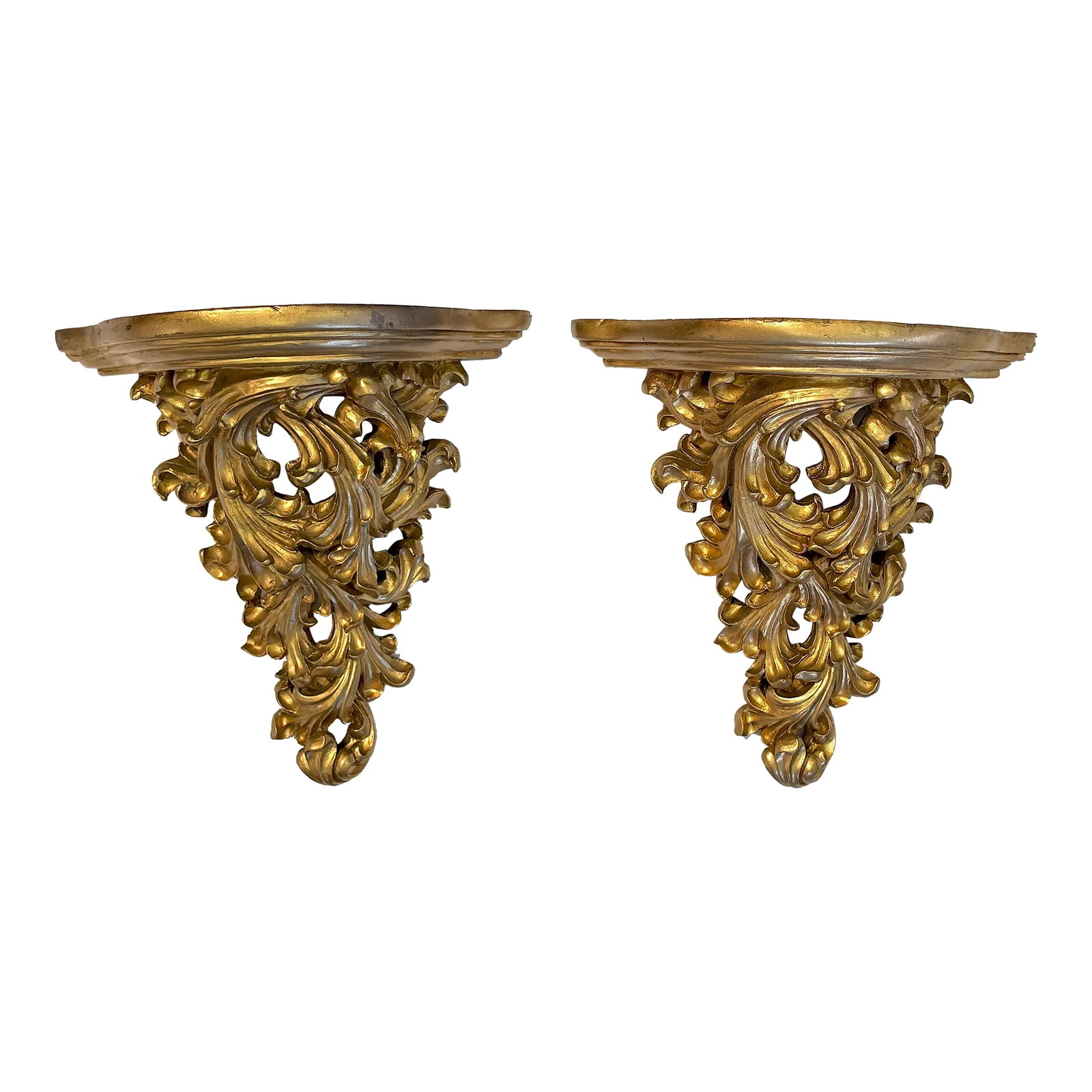Vintage Hollywood Regency Style Wall Brackets- a Pair: Pretty pair of Hollywood Regency style wall brackets from the late 20th century. They are made of molded resign with a carved wood look and painted in a warm gold finish. The shelves have a small