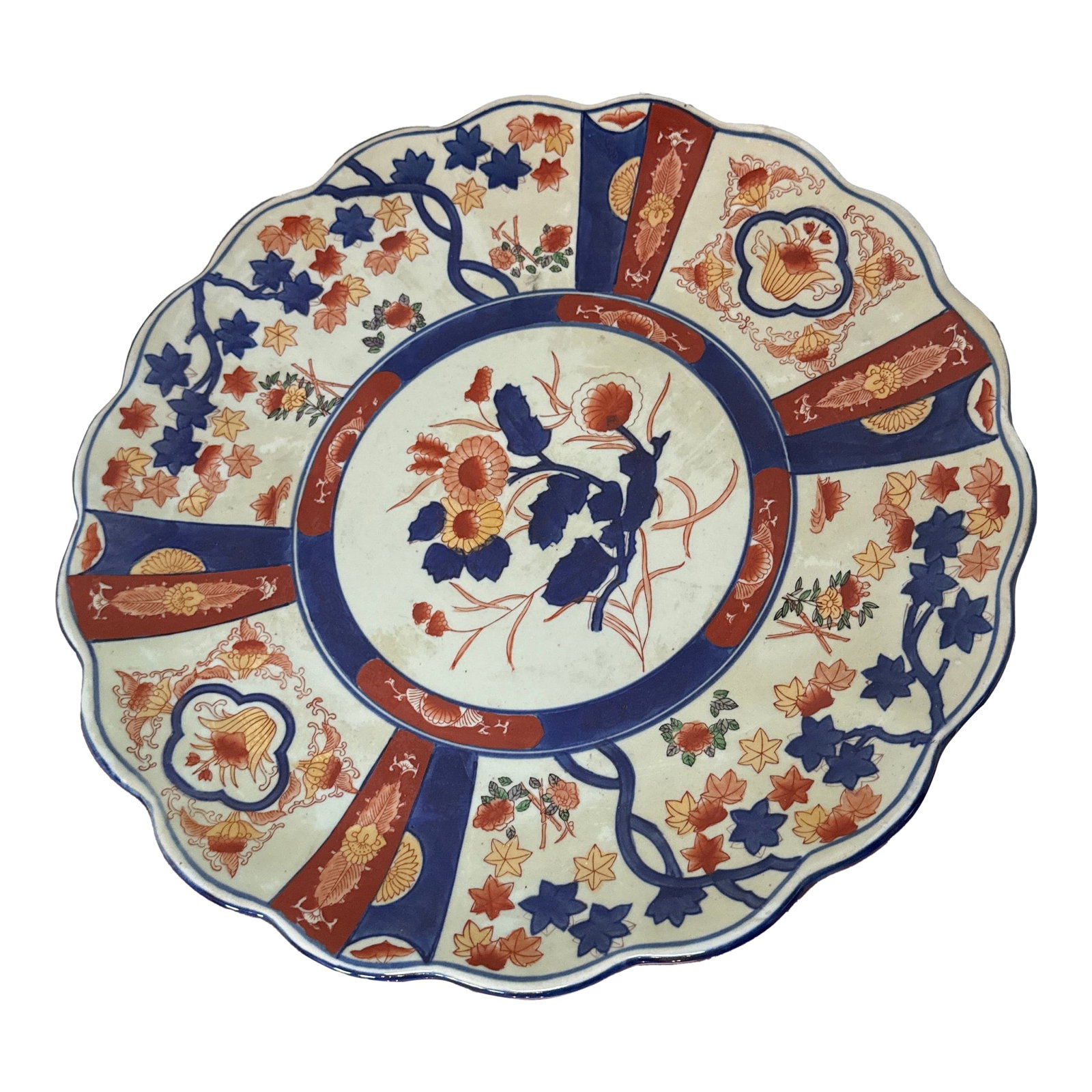 Vintage Oversized Imari Plate With Scalloped Edges and Floral Pattern: Antique Hand Painted Imari Plate With Scalloped Edges and Floral Pattern From Japan - Circa 1900.The plate is a large, decorative, and colorful piece of art. It features a blue and white design, with