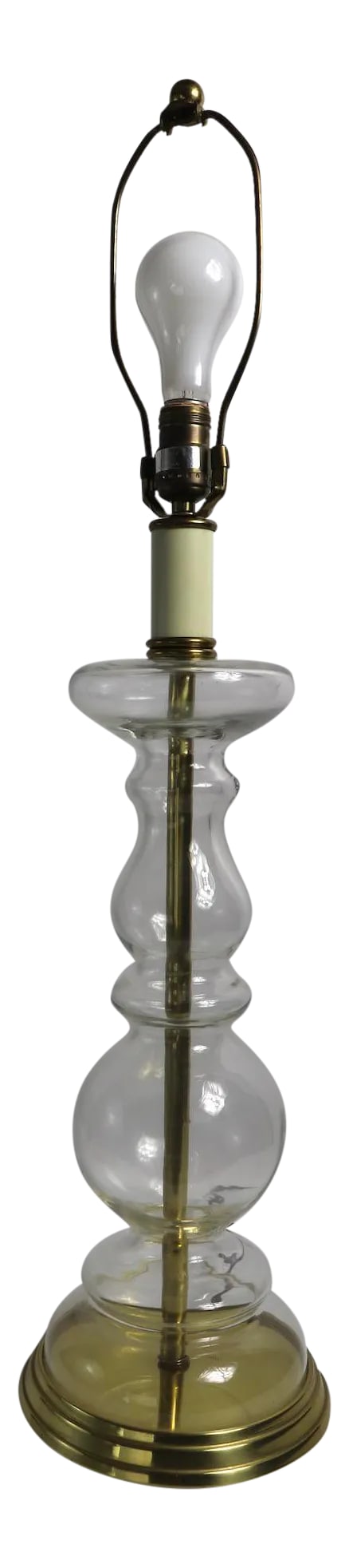 Clear Glass Table Lamp by Tyndale: Clear glass table lamp in the form of a large candlestick, made by Tyndale. This example is in very fine, original and working condition, shade not included. Total H 34" x H to top of glass element