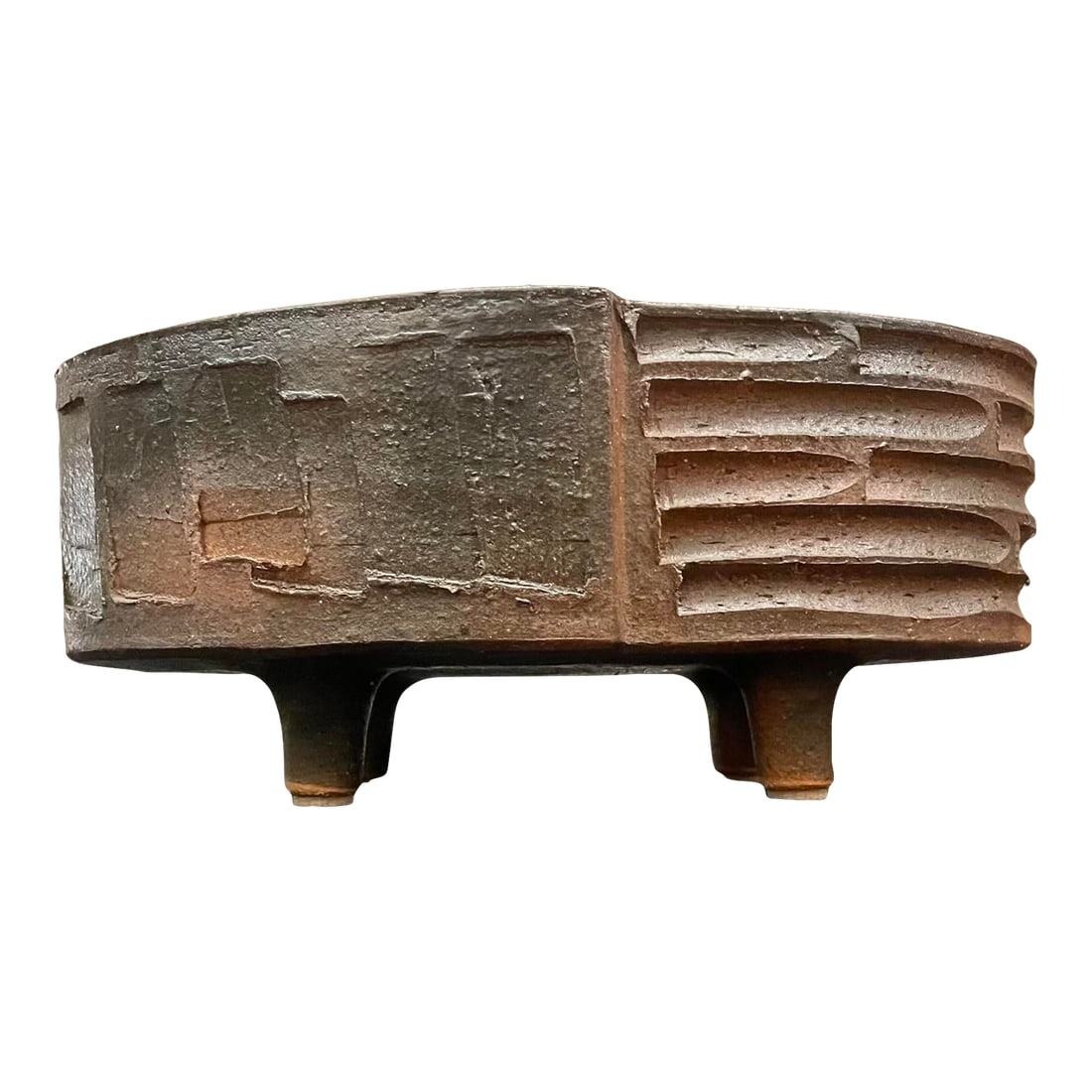 Oval Japanese Ikebana Planter, Footed Stoneware Vessel, Mid-20th Century: A sculptural piece of mid-century Japanese studio pottery, this low oval vessel is elevated on four sturdy feet and features deeply incised geometric carving around its dark stoneware body. The form