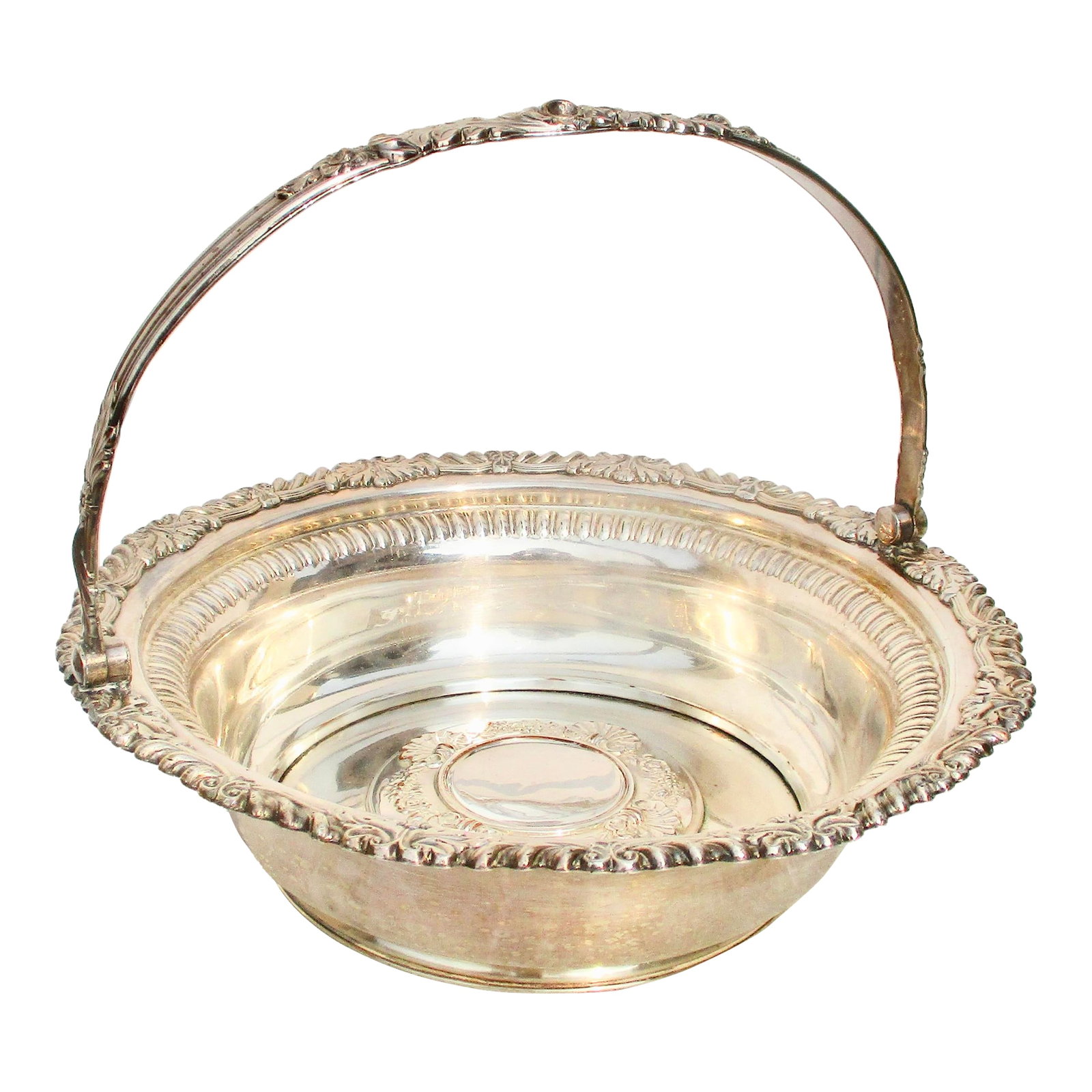 Antique Shefflield Plate Swing Handle Basket: Antique Shielfield Plate swing handle basket. A heavy body and solid construction of the basket. The piece dates circa 1850, though no marks are seen. The measurements are 11" in diameter and 3" tall