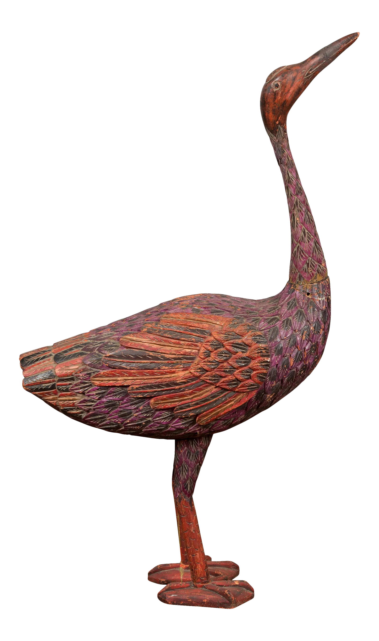 Indonesian Hand Carved Heron Sculpture with Purple, Orange and Black Tones: A vintage Indonesian hand carved heron sculpture from the mid-20th century, with polychrome finish. Hand carved in Indonesia during the midcentury period, this sculpture depicts a standing heron