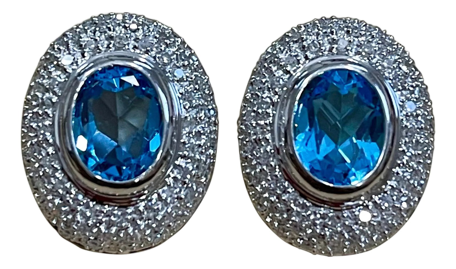 5 Carat Oval Shape Blue Topaz and Diamond Omega Back Clip Earring 14 Karat Gold: 5 Carat Oval Shape Blue Topaz & Diamond Omega Back Clip Earring 14 Karat White Gold Two Blue Topaz weighing approximately 5 carats Total Each Blue Topaz is over 2.5 ct Natural Nice Blue topaz