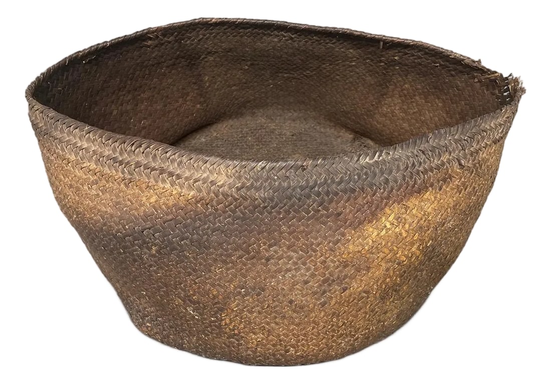 Antique Oversized Hand Woven Rattan Basket: Discover a stunning handwoven large basket from Sumatra, crafted circa 1950. Ideal for storing magazines, towels and more. It offers a luxurious minimalism for those who appreciate the