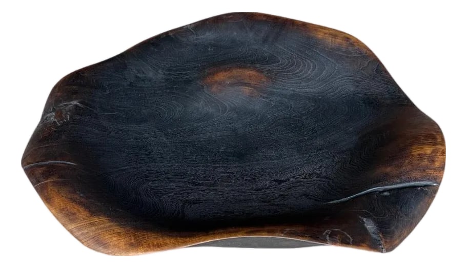 Andrianna Shamaris Charred Sculptural Bowl Or Platter: Large amorphous bowl or platter hand made from an impressive century old single piece of teak wood. Both usable and sculptural. Charred with a gradation finish revealing the unique wood grain. It's