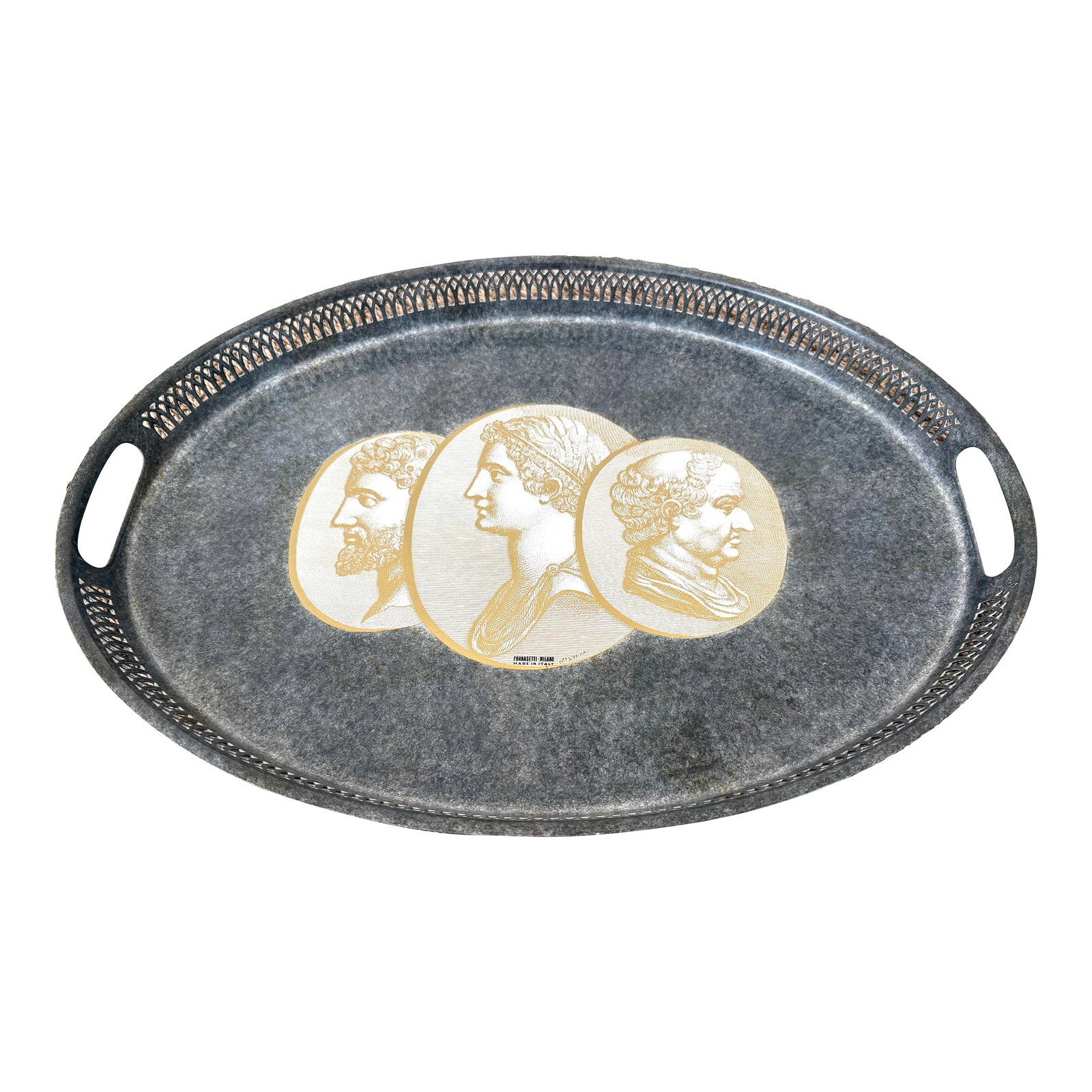 Fornasetti Oval Metal Enameled Tray With Roman Profiles: Vintage Italian oval enameled metal tray depicting gold coins with profiles of Roman men. Silver/gray with filigreed sides. Made in Milan Italy, this piece is signed and numbered. Original Fornasetti 