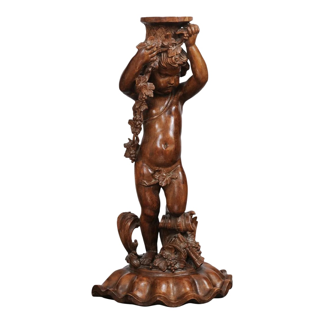 French Napoléon III 1860s Carved Walnut Sculpture of a Putto Carrying a Vessel: A French Napoléon III period walnut carved putto sculpture from the mid 19th century, with grapes, flowers and the double flute. Created in France during the third quarter of the 19th century,