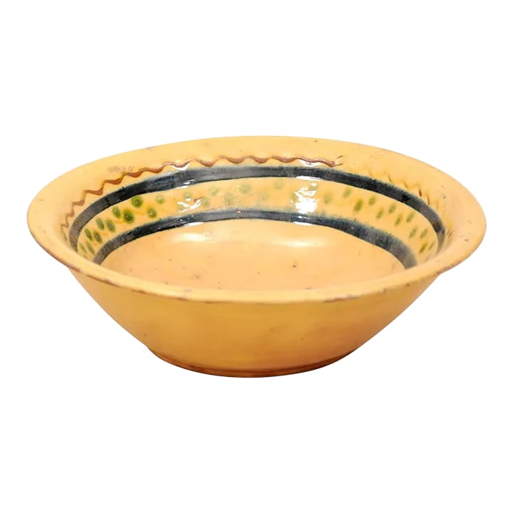 French 19th Century Bowl from the Poterie Hertz of Annecy, with Yellow Glaze: A French 19th century pottery bowl from the Poterie Hertz in Annecy, with yellow glaze. Created in the Alpine town of Annecy in Southeastern France, this pottery bowl features a circular yellow