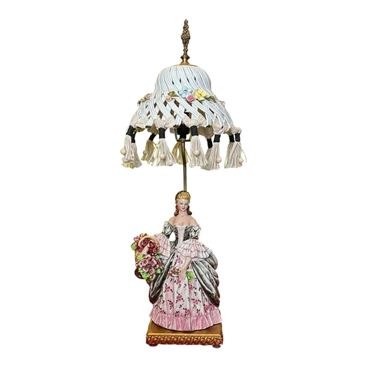 1930's Capodimonte Carlo Mollica Porcelain Table Lamp Lady With Flowers: This porcelain masterpiece was crafted in the 1930s by Carlo Mollica a luminary of Capodimonte Italy. The centerpiece is a stunning young woman with golden tresses, her beauty immortalized in delicate