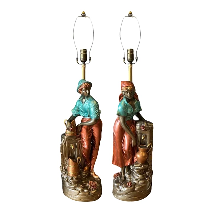 Vintage Chalkware Table Lamp: Villagers Fetching Water- a Pair: This striking Mid-Century Chalkware Table Lamp draws inspiration from the acclaimed Royal Dux figurines and capture a tender scene of village life: a young man and woman gathering water from a well. T