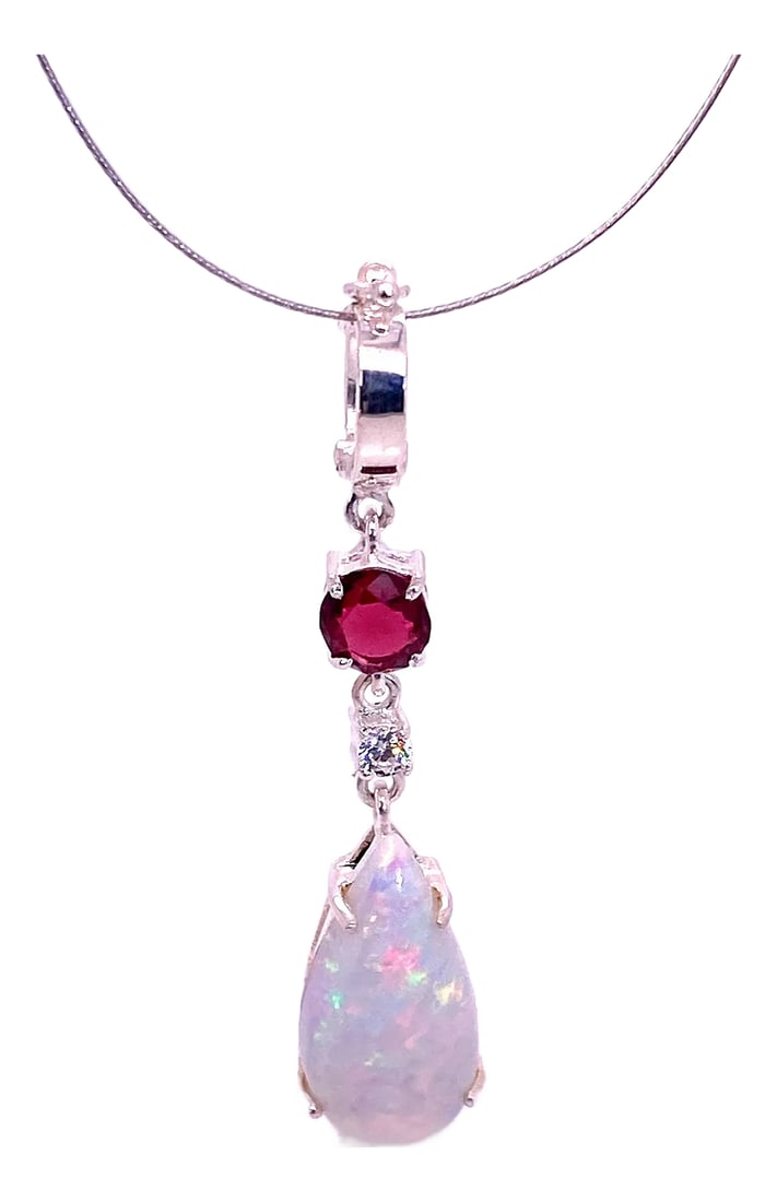 Opal Pendant With Accents of Garnet and Zircon: Exquisite Drop-Shaped Opal Pendant with Garnet Accent in Sterling Silver Discover the stunning beauty of this drop-shaped Opal pendant, bursting with vivid flashes of red, blue, and green. Crafted in 