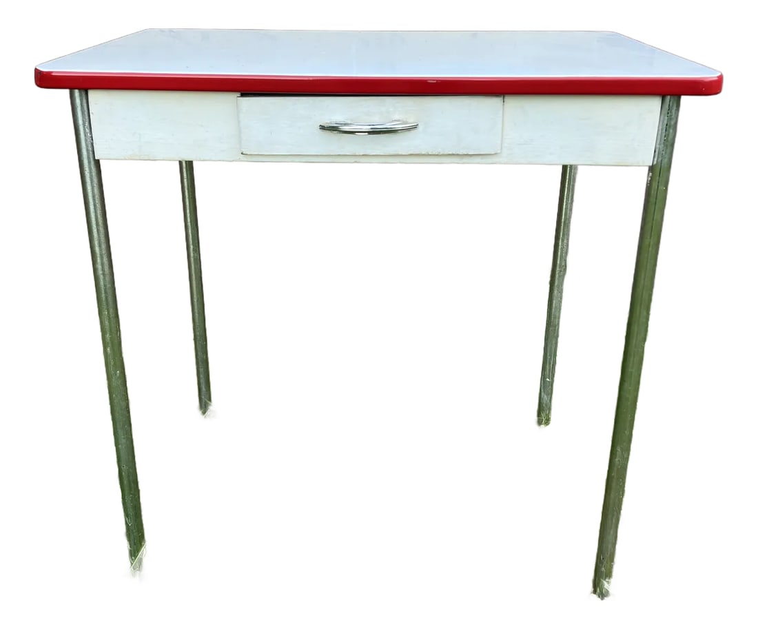 Charming Farmhouse Style White Enamel Top Table: Mid century farmhouse style porcelain/enamel top white wooden table with bright red trim, metal base, and metal legs. Single wooden drawer on front side opens well with original chrome handle. The und