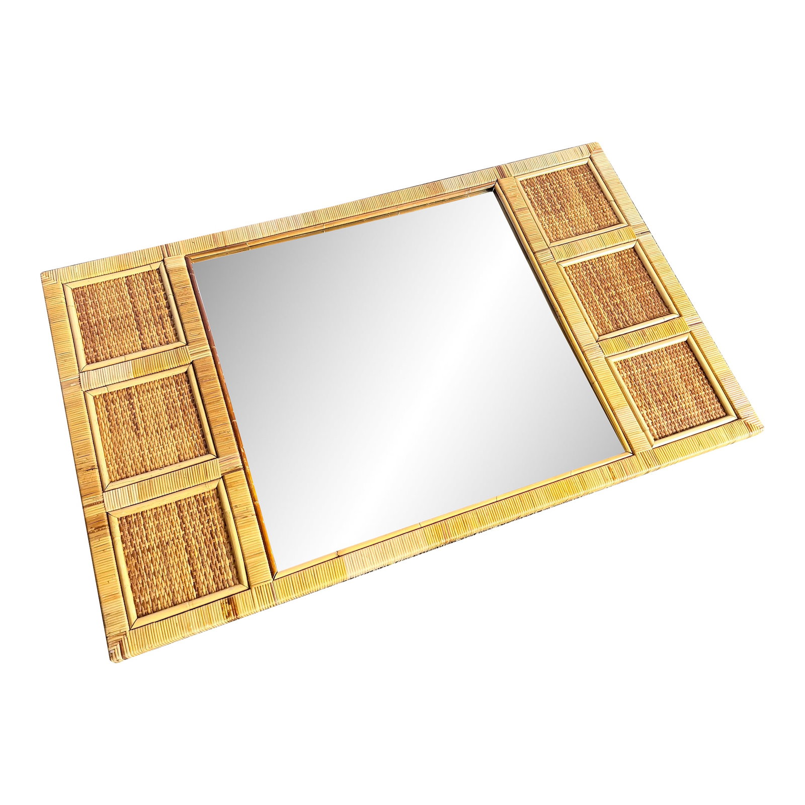 Vintage Boho Coastal Wicker Paneled Wall Mirror: Effortlessly breezy and beautifully textured, this vintage Boho Coastal wall mirror is framed in woven wicker panels with rattan accents. Its rectangular shape and earthy natural finish evoke the rela