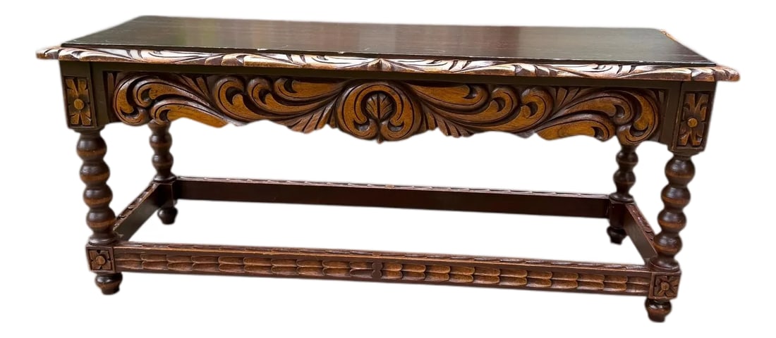 Spanish Baroque Carved Wood Arts & Crafts Hall Bench Seat: Offering a restored vintage Spanish baroque side bench for two showcasing deep relief hand-carving. Prominent and elaborate, floral and scrollwork hand-carvings along the apron of the table directly