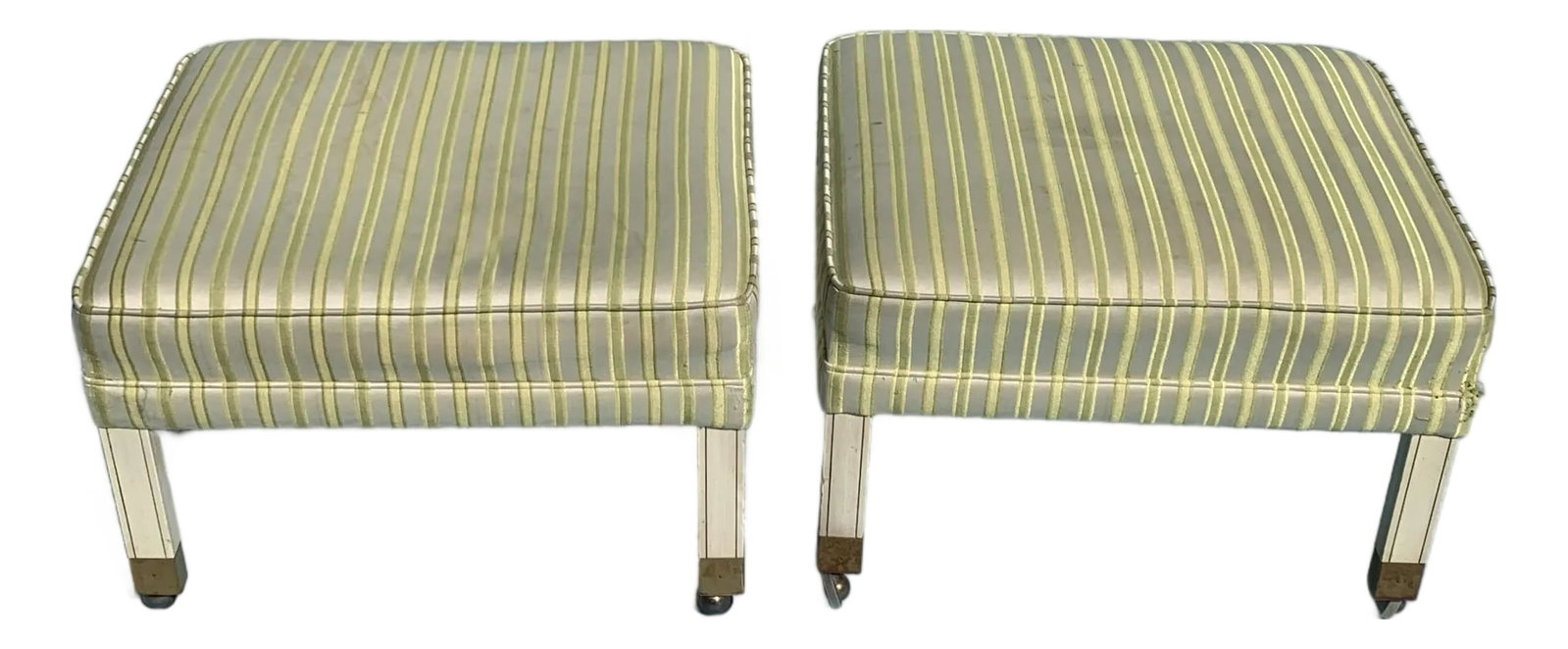 1960s Vintage Mid Century Ottomans on Brass Casters, Set of 2: 1960s Mid century style ottomans, upholstered in striped yellow cotton blend fabric. With antique brass casters and painted white legs. Set of 2. Condition: Alterations: Original Condition Unaltered I