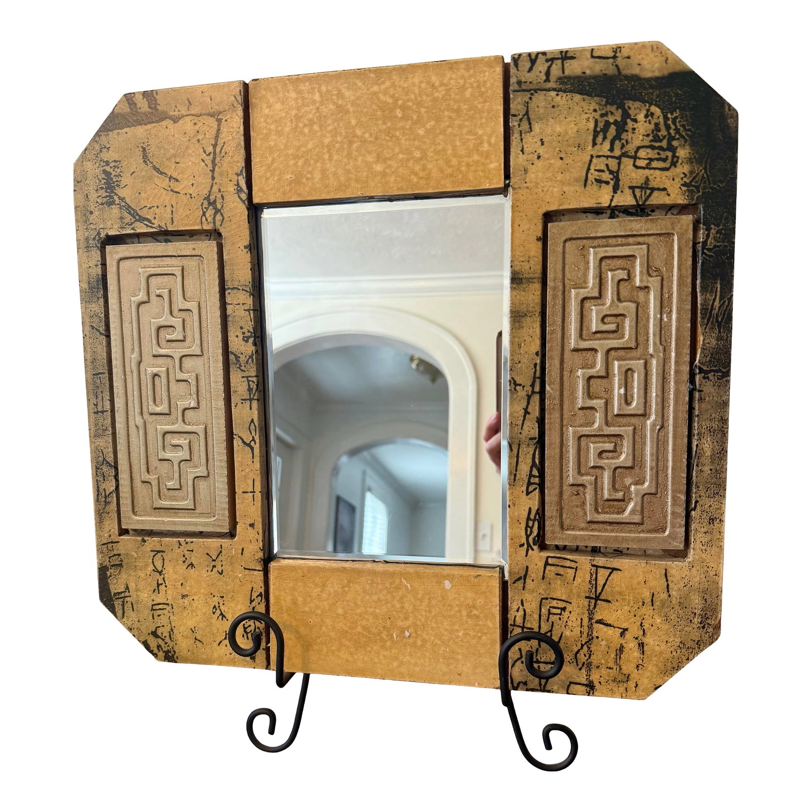 Hollywood Regency Mirror With Greek Key Motif: The most distinctive feature of this vintage framed mirror is the raised, intricate Greek key or labyrinthine pattern adorning the side panels of the frame, evoking a blend of classical and Hollywood