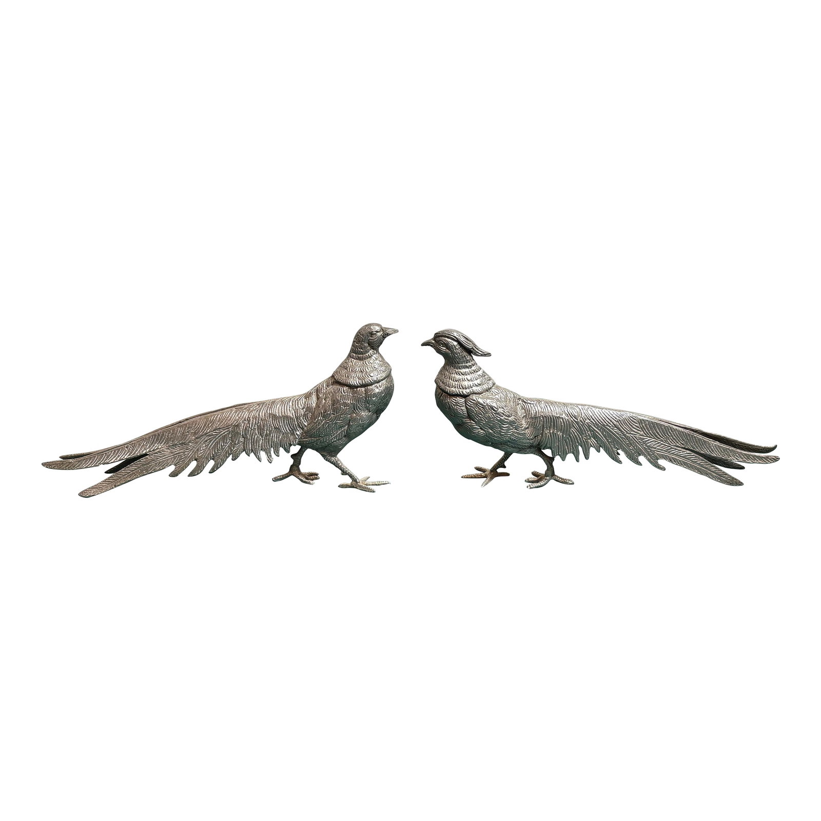 Vintage Pair of Metal Chinese Pheasant Sculptures- A Pair: These silver style pheasents are a pair of male and female birds who are in a relaxed pose as they are birds who mate for life. A pheasant is a large ground dwelling bird known for it's long beautiful