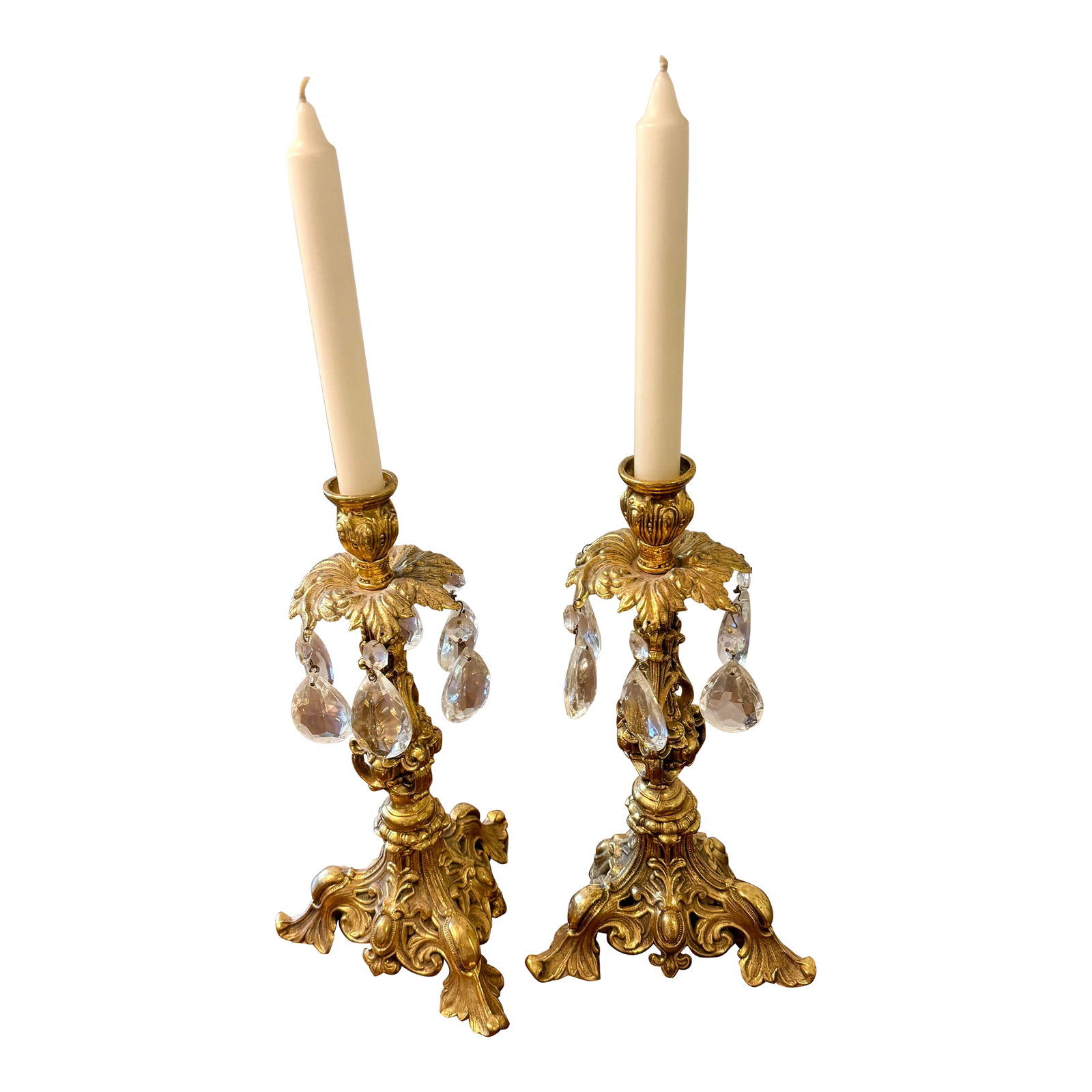 Ornate Gold Candle Holders With Crystal Prisms: This pair of vintage candle holders are characterized by their elaborate gold colored metalwork and dangling crystal prisms. Designed to hold tapered candles, creating an elegant and luxurious