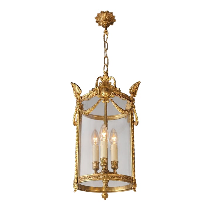 Antique French Lantern Chandelier Louis XVI Style Brass and Glas Gold Handmade: A classic lantern chandelier with a clear form and refined decorative details. The cylindrical structure is enclosed by a glass body, allowing the light to spread evenly and softly. The upper decorati