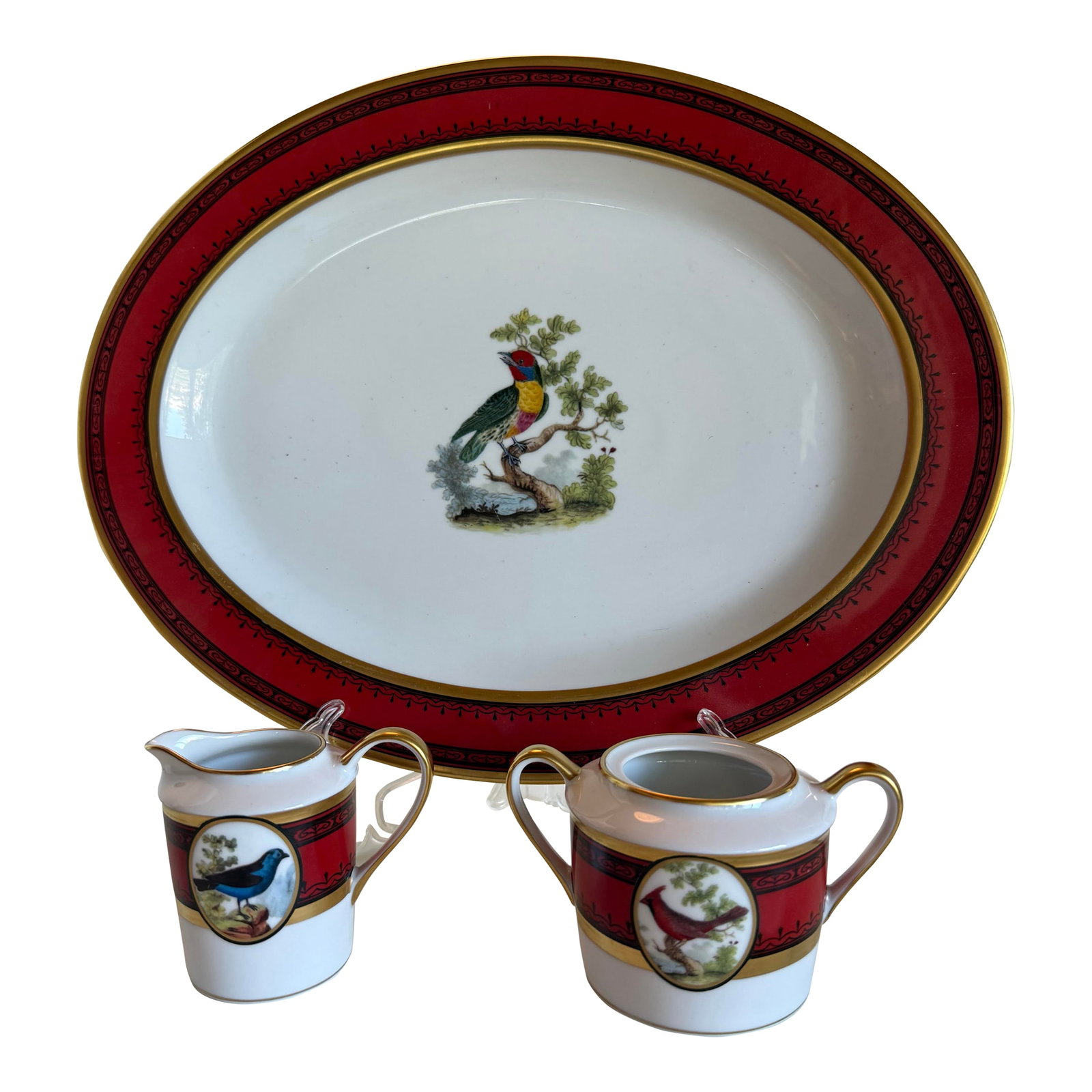Early 20th Century Tray Creamer and Sugar Ancienne Manufacture Royale De Limoges "Jardin Du Roi": A refined three-piece serving group from the Ancienne Manufacture Royale de Limoges, France, in the celebrated "Jardin du Roi" pattern. The set comprises a large oval serving platter, a covered sugar