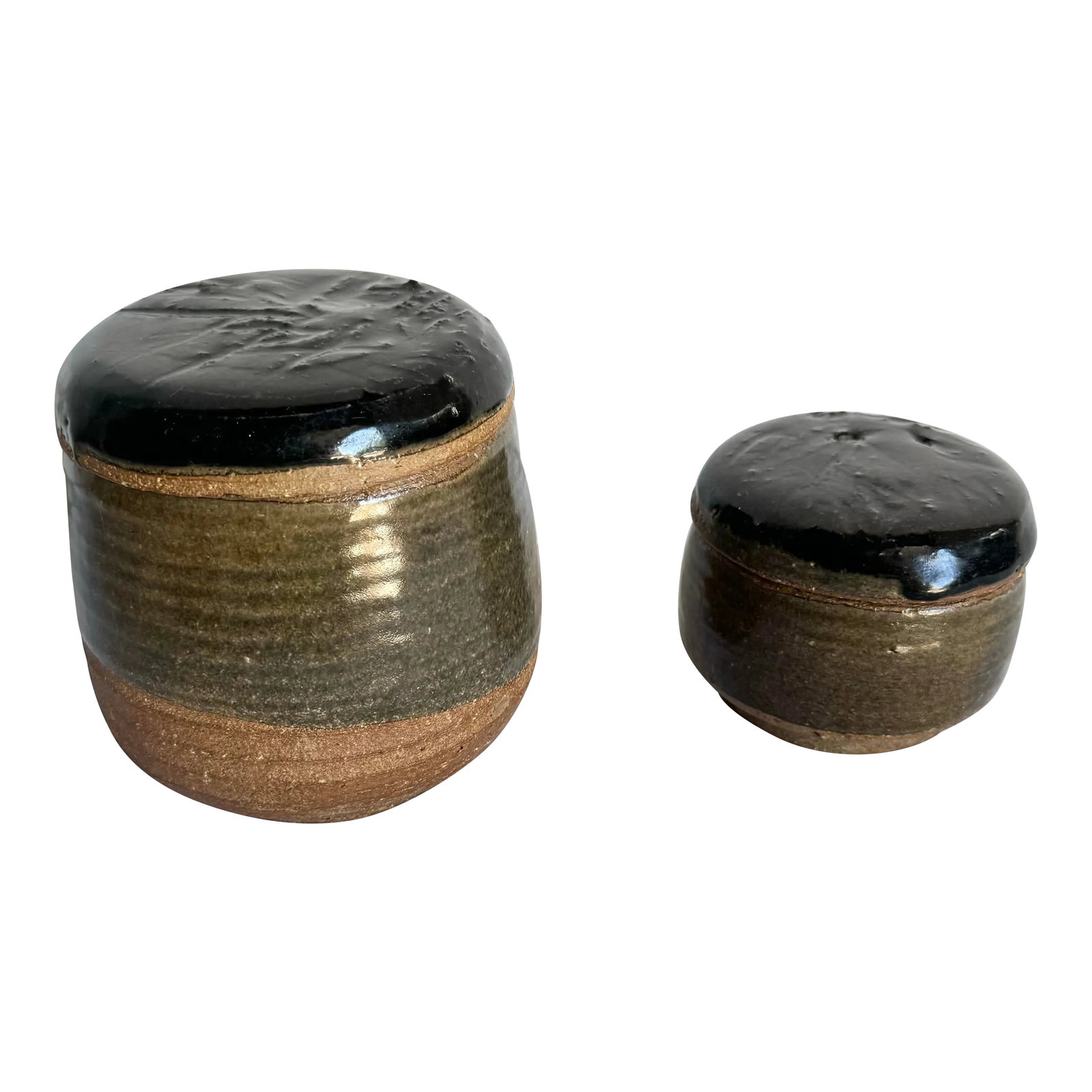 Vintage Hand Made Pottery Jars With Lids - 2 Pieces: This set of vintage handmade pottery jars showcases timeless craftsmanship with their earthy tones and natural textures. Featuring glossy black lids and a two-tone design of glazed and unglazed clay,
