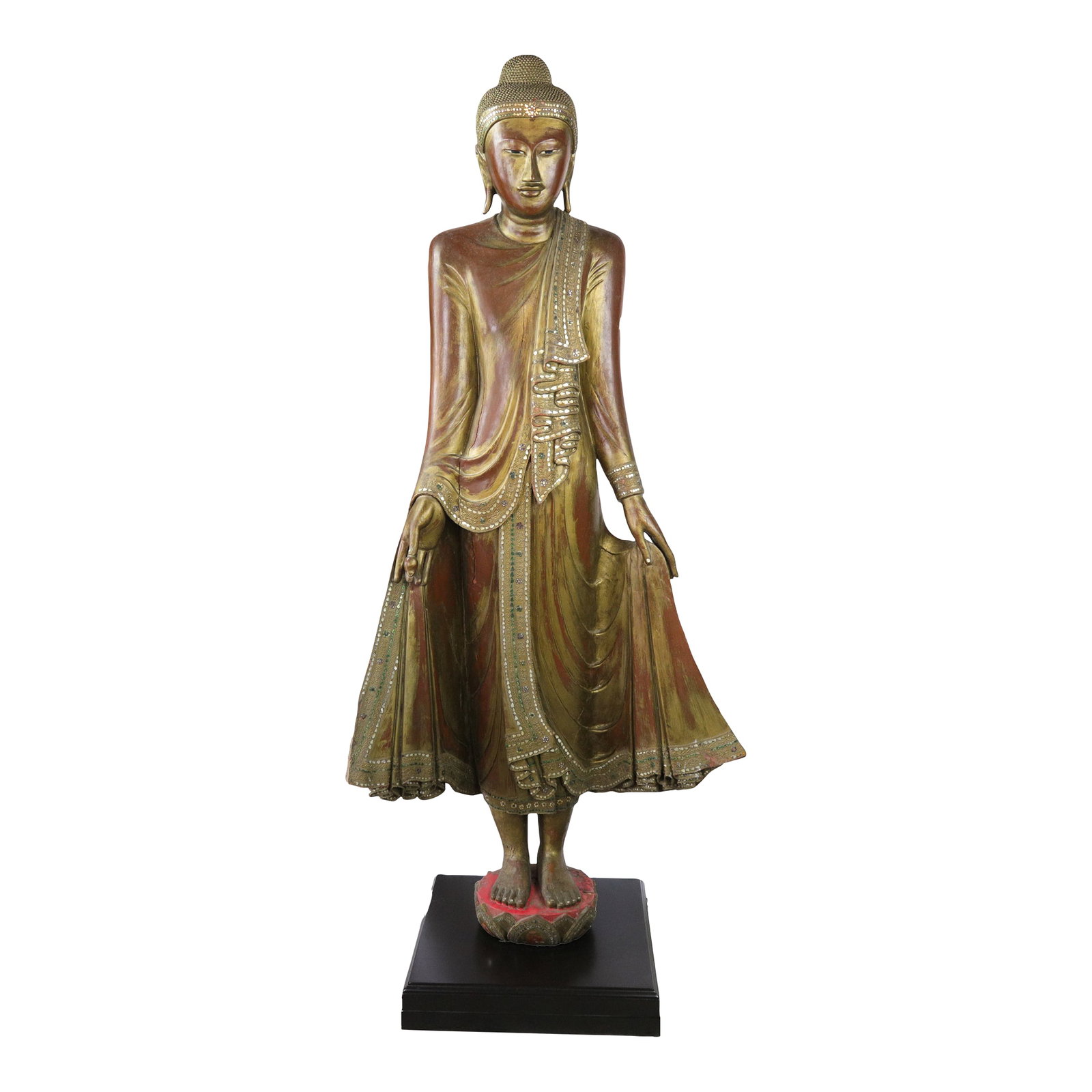 20th Century Thai Burmese Mandalay Style Standing Wooden Buddha Statue on Black Base: This Buddha statue is made of woodcarving, with gold foil and inlaid glass or semi-precious stones on the surface, showing the typical style of the Buddha statues of the Mandalay Dynasty of Burma in t